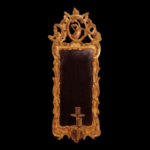 A gilt 18th century Rococo mirror. Northgermany 
circa 1760. H: 59cm. W: 22cm
