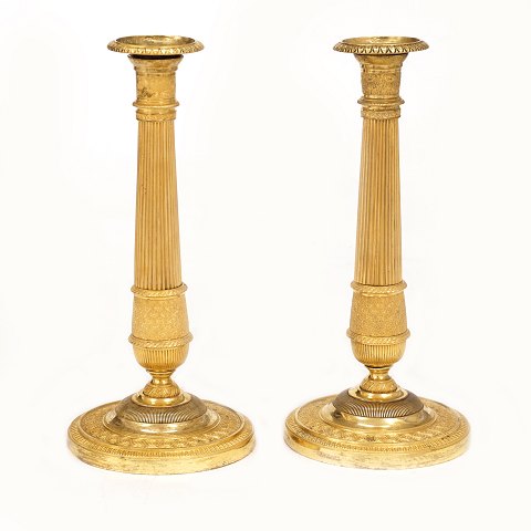 A pair of firegilt candlesticks. France circa 
1810-20. H: 27cm