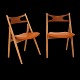 Hans J. Wegner, Denmark: Set of four "Sawhorse Chairs", CH29, by Carl Hansen & 
Søn, Denmark, with new upholstery