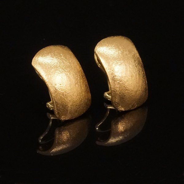 A pair of 14kt gold ear clips. Size: 11x18mm