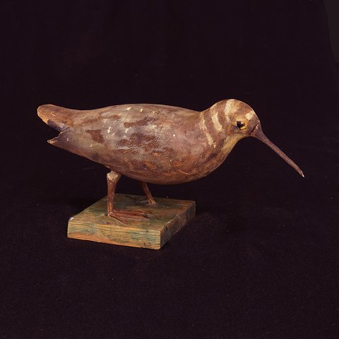 Swedish folkart: A bird, wood. Late 19th Century. H: 15cm. L: 32cm