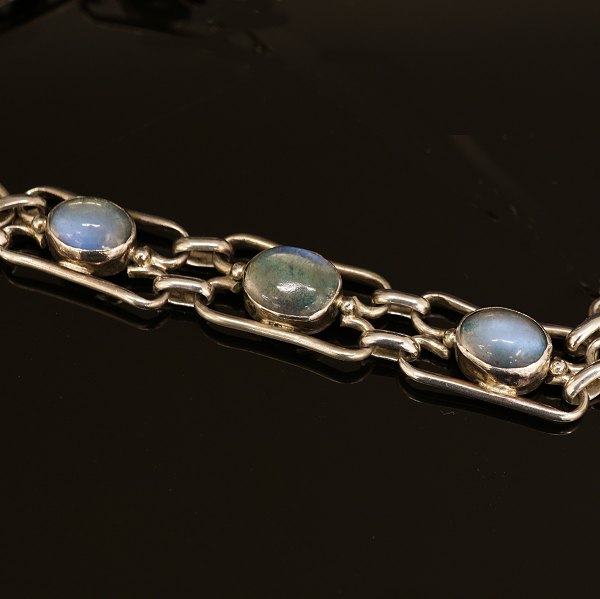 Silver bracelet with moonstones. Signed A.H.W. L: 19cm