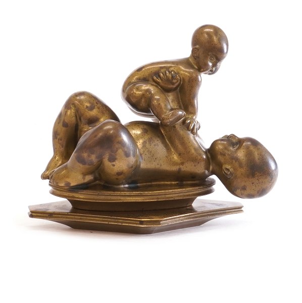 Bronze sculpture by Kai Nielsen, 1882-1924, in the shape of a girl holding a bay. Signed. H: 13cm. L: 16cm
